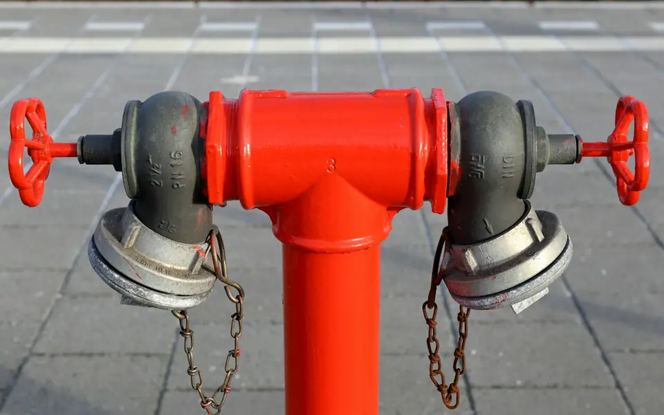 Red fire hydrant with twin outlets