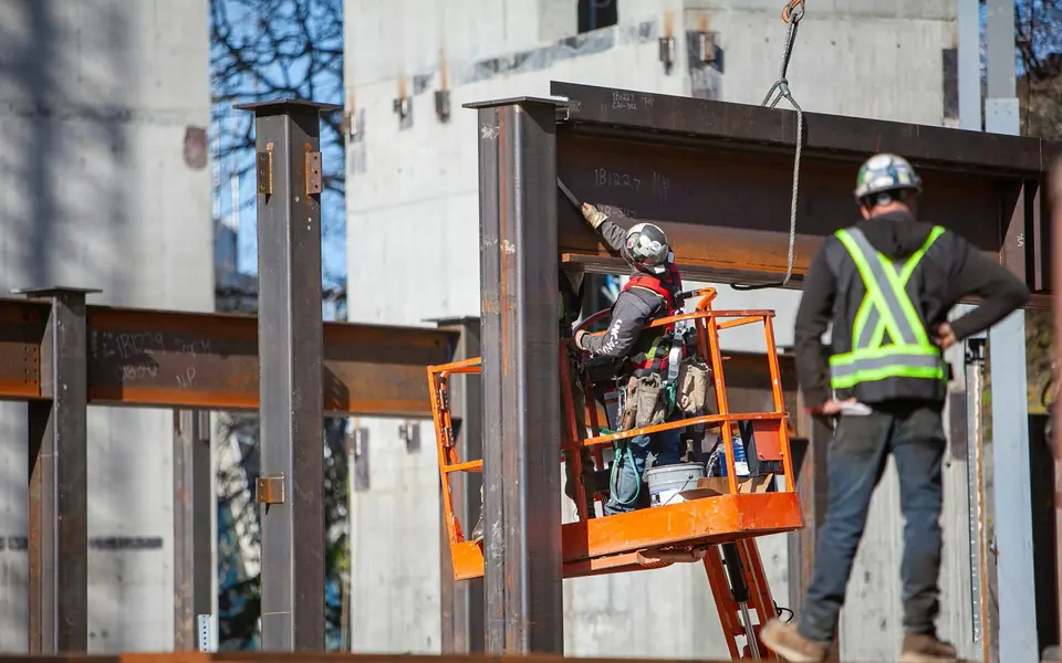 Steel erectors installing structural steel beams