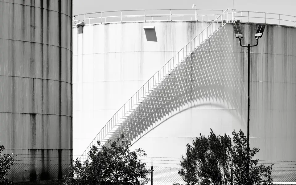 Large industrial storage tanks with a spiral staircase